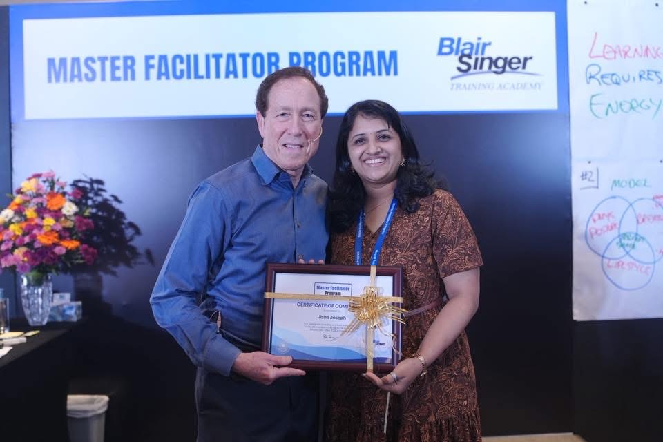 Jisha Joseph receiving her Master Facilitator Programme certificate with Blair Singer